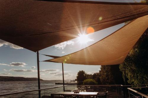 restaurant terrace seashore ray sun through awning